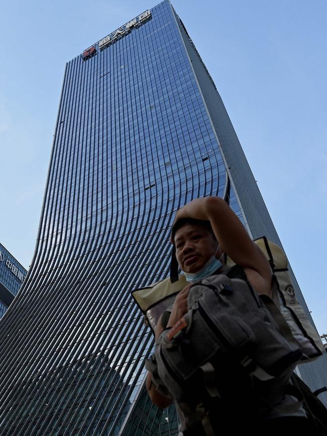 A man walks in front of the Evergrande headquarters in Shenzhen. Picture: AFP