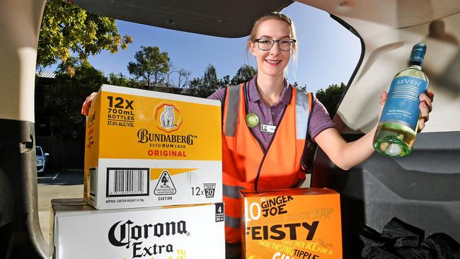 Customer assistant at Dan Murphy’s Holland Park outlet Hannah Musson loads up a car boot. Picture: John Gass