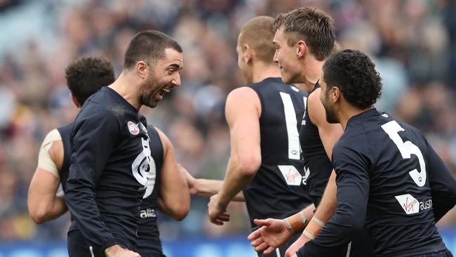 Kade Simpson (left) celebrates after kicking a goal for the Blues against the Crows at the MCG. Picture: AAP Image/David Crosling