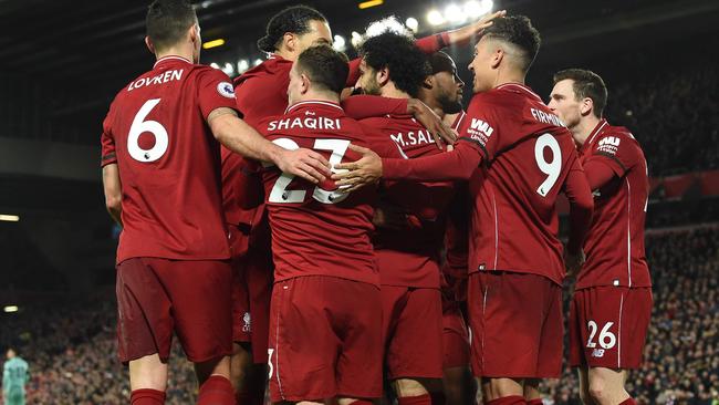 Liverpool's Brazilian midfielder Roberto Firmino (2R) celebrates shooting from the penalty spot to score his team's fifth goal during the English Premier League football match between Liverpool and Arsenal at Anfield in Liverpool, north west England on December 29, 2018. (Photo by Paul ELLIS / AFP) / RESTRICTED TO EDITORIAL USE. No use with unauthorized audio, video, data, fixture lists, club/league logos or 'live' services. Online in-match use limited to 120 images. An additional 40 images may be used in extra time. No video emulation. Social media in-match use limited to 120 images. An additional 40 images may be used in extra time. No use in betting publications, games or single club/league/player publications. /