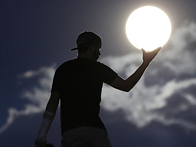 Tim Braitling watching the Supermoon at the Gold Coast Spit Pic Peter Wallis