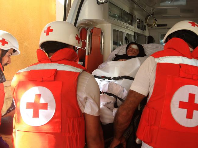 Lebanese Red Cross volunteers transport injured 32-year-old Zainab Khalifeh from the Alaa Addin hospital in the southern town of Sarafand, to be transferred by ambulance to a specialised medical institution in Beirut for the continuation of her treatment, on November 5, 2024. An Israeli strike on Sarafand, some 15 kilometres (nine miles) south of the coastal city of Sidon, flattened an apartment complex and killed 15 people, many of them Zainab's relatives, according to residents. (Photo by Mahmoud ZAYYAT / AFP)