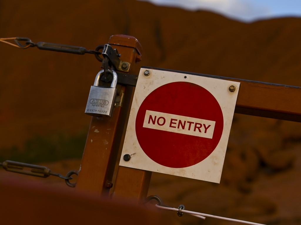 The locked gate to the climbing area at Uluru, also known as Ayers Rock is seen at Uluru-Kata Tjuta National Park in the Northern Territory, Friday, October 11, 2019. (AAP Image/Lukas Coch) NO ARCHIVING