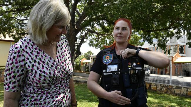 Infrastructure, Planning and Logistics Minister Eva Lawler with Transit Safety Officers Sarah Reese showing her where her capsicum spray canister is kept.