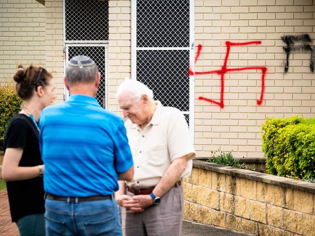 Synagogue President George Foster with members of the community outside the vandalised synagogue in Alawah. Photo: Tom Parrish