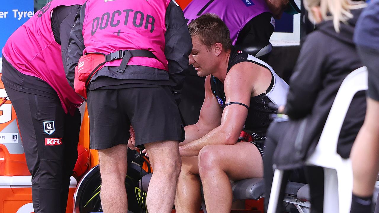 ADELAIDE, AUSTRALIA - MAY 19: Ollie Wines of the Power in the hands of Doctors on the bench during the 2024 AFL Round 10 match between Yartapuulti (Port Adelaide Power) and the Hawthorn Hawks at Adelaide Oval on May 19, 2024 in Adelaide, Australia. (Photo by Sarah Reed/AFL Photos via Getty Images)