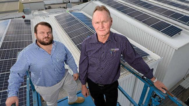 GLOBAL AMBITION: GEM Energy's Jack Hooper (left) and Dobinsons Spring and Suspension's Glen Dobinson of with a small part of the solar panel array on top of Dobinsons' roof.