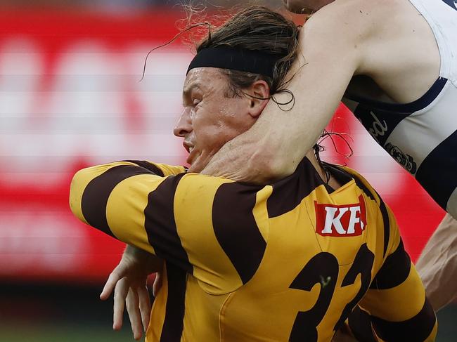 Play on: Jack Ginnivan of the Hawks gets taken high by Max Holmes but no free kick was given during the third quarter. Picture: Michael Klein