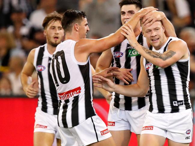 MELBOURNE, AUSTRALIA - MARCH 28: Jordan De Goey of the Magpies celebrates a goal with Scott Pendlebury of the Magpies and Brayden Maynard of the Magpies during the 2019 AFL round 02 match between the Richmond Tigers and the Collingwood Magpies at the Melbourne Cricket Ground on March 28, 2019 in Melbourne, Australia. (Photo by Dylan Burns/AFL Photos)