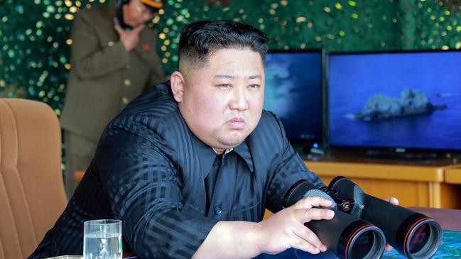 Kim Jong-un supervises a test of long-range multiple rocket launchers and tactical guided weapons into the East Sea this month. Picture: KNCA via AFP