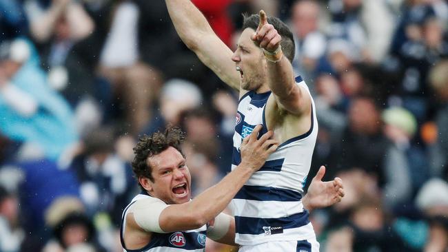 Harry Taylor and Steve Motlop celebrate the Cats’ win.