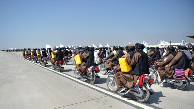 Taliban military personnel carrying a dummy yellow canister intended to be containing homemade explosives, at the takeover anniversary parade. Picture: AFP