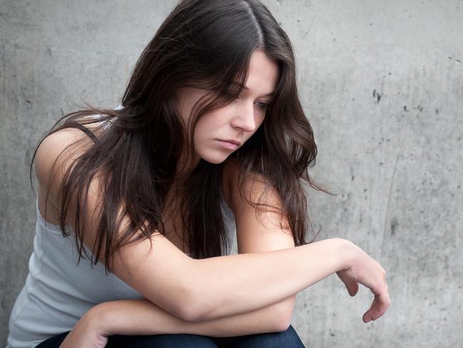 Teenage girl looking thoughtful about troubles