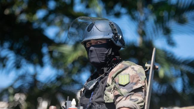 A security official looks on from an armoured vehicle in Noumea. Picture: Delphine Mayeur/AFP