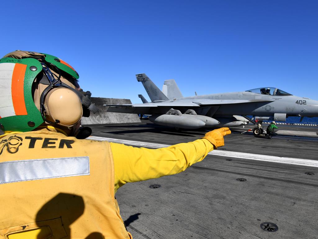 Crew are seen preparing a F/A-18E Super Hornet for take off. Picture: AAP Image/Darren England