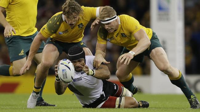 Fiji's Netani Talei is tackled by Australia's David Pocock, right, and Michael Hooper during the Rugby World Cup Pool A match between Australia and Fiji at the Millennium Stadium, Cardiff, Wednesday, Sept. 23, 2015. (AP Photo/Matt Dunham)