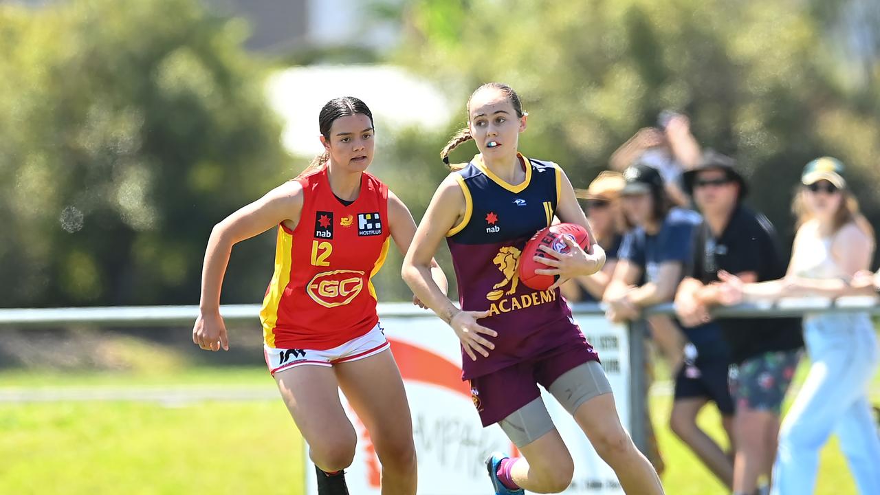 Mia Geere of the Lions handles the ball in front of Evy Reeves last year. (Photo by Albert Perez/AFL Photos via Getty Images)