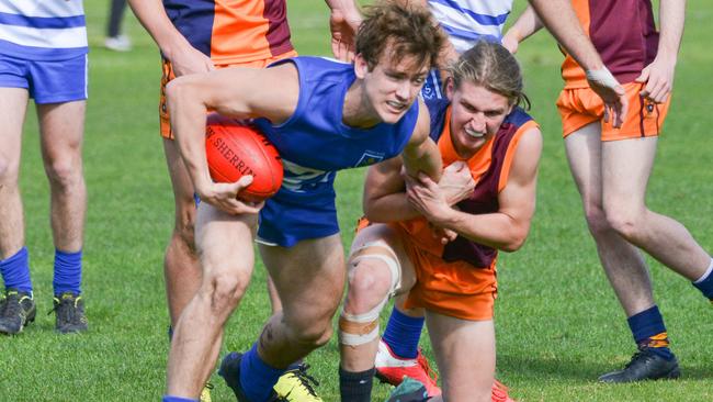 Lachie DeCesare (St Peter’s) and St Michael’s s skipper Zac Buck wrestle for the ball. Picture: Brenton Edwards