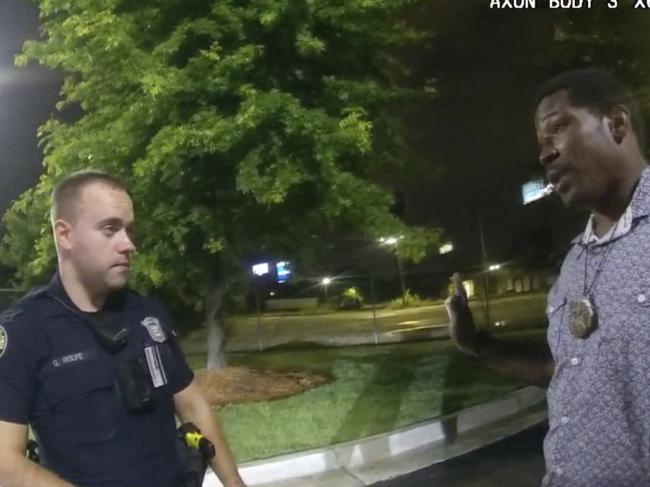 This screen grab taken from body camera video provided by the Atlanta Police Department shows Rayshard Brooks speaking with Officer Garrett Rolfe in the parking lot of a Wendy's restaurant, late Friday, June 12, 2020, in Atlanta. Rolfe has been fired following the fatal shooting of Brooks and a second officer has been placed on administrative duty. (Atlanta Police Department via AP)