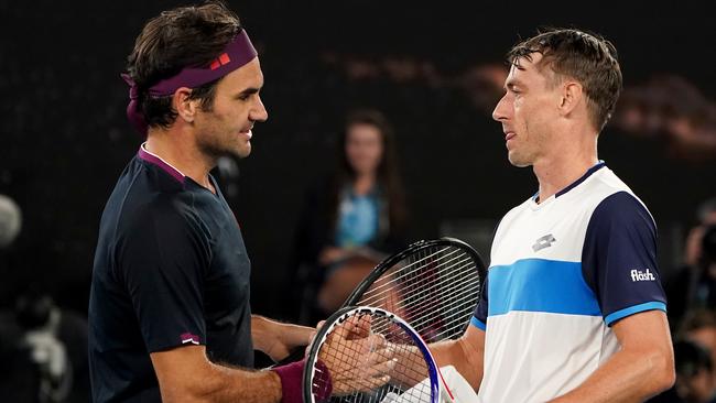 John Millman with Roger Federer after that Australian Open 5-set epic in 2020. Picture: AAP Image/Dave Hunt