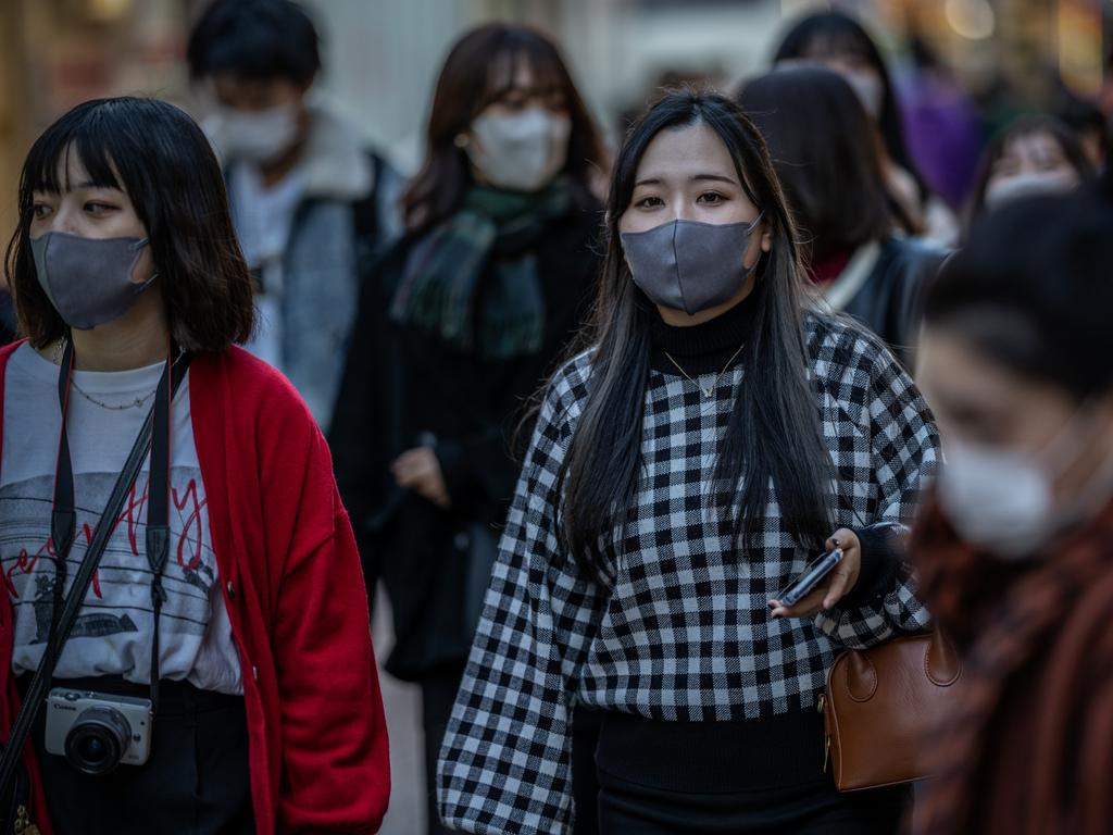 Women wearing face masks walk along a shopping street in Tokyo, Japan. The country has closed its doors to foreigners until at least December 31. Picture: Getty Images