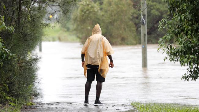 A man looks at floodwaters in Morayfield, north of Brisbane. Picture: Josh Woning