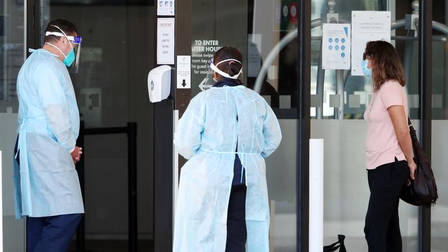 A guest waits to be escorted into the Holiday Inn at Melbourne Airport. Picture: NCA NewsWire/David Crosling