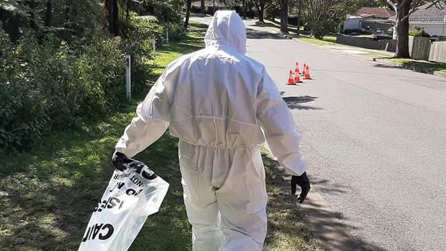 A firefighter from NSW Fire &amp; Rescue's Forestville Brigade cleans up dangerous asbestos material dumped in a residential area on the northern beaches. Picture: NSW Fire &amp; Rescue