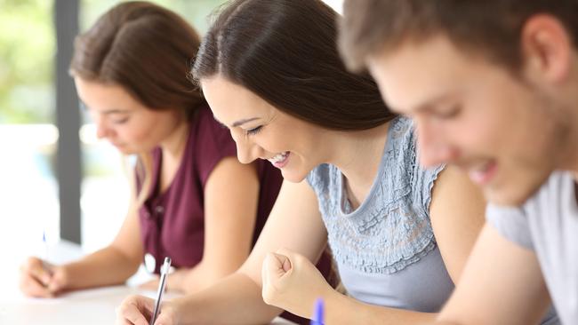 Excited student during an exam at classroom