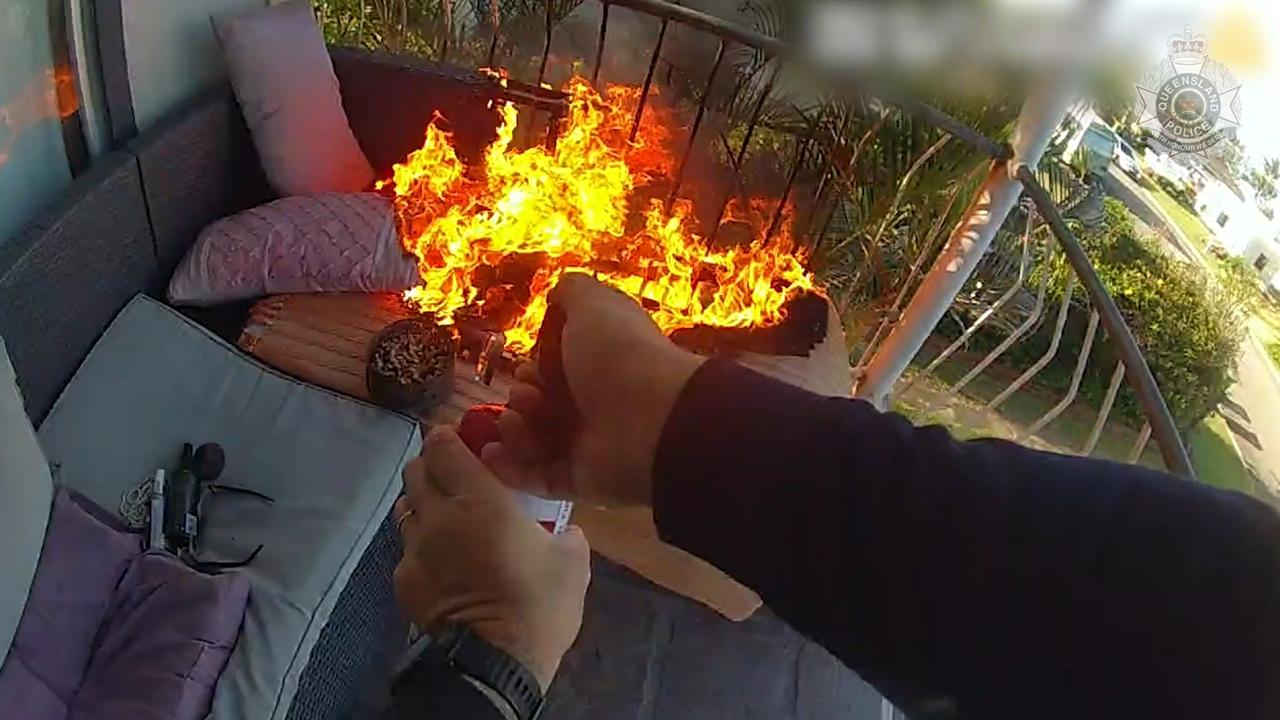 Constable Alexander Campbell of Ingham Police uses an extinguisher to put out a burning plastic couch on the second storey of a home during a dramatic incident recently. Picture: Supplied