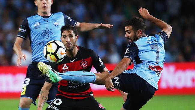 Sydney FC’s Michael Zullo and Wanderers’ Alvaro Cejudo have their eye on the ball. Picture: Phil Hillyard