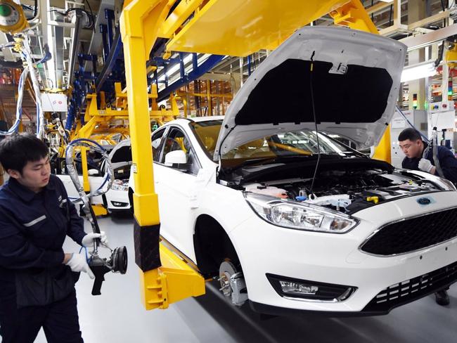 Workers assemble a vehicle at a Changan Ford plant in Harbin China. Ford Motor Co. joined with Changan Automobile to operate the plant in China, as Beijing requires foreign companies to form joint ventures with domestic firms within the country. China’s rules requiring foreign companies to form joint ventures with domestic partners are among the chief targets of the Trump administration’s looming tariffs against Chinese imports. jpg