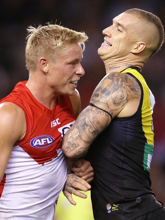 Isaac Heeney and Dustin Martin clash last season.