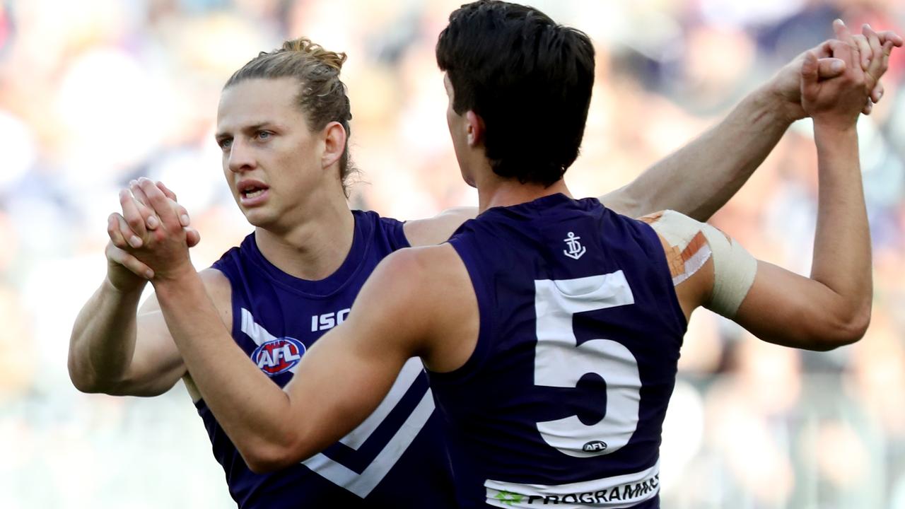 Nat Fyfe (left) of the Dockers is congratulated by Adam Cerra after kicking a goal during the Round 23 AFL match between the Fremantle Dockers and the Collingwood Magpies at Optus Stadium in Perth, Saturday, August 25, 2018. (AAP Image/Richard Wainwright) NO ARCHIVING, EDITORIAL USE ONLY