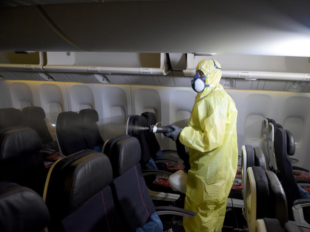 A worker disinfects the cabin area of an Air France plane at Roissy-Charles de Gaulle Airport. Picture: Eric Piermont / AFP