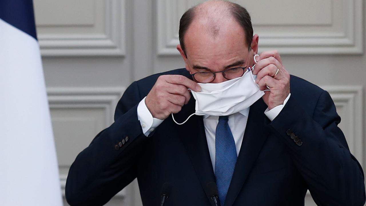 French Prime Minister Jean Castex puts on a face mask. Picture: AFP