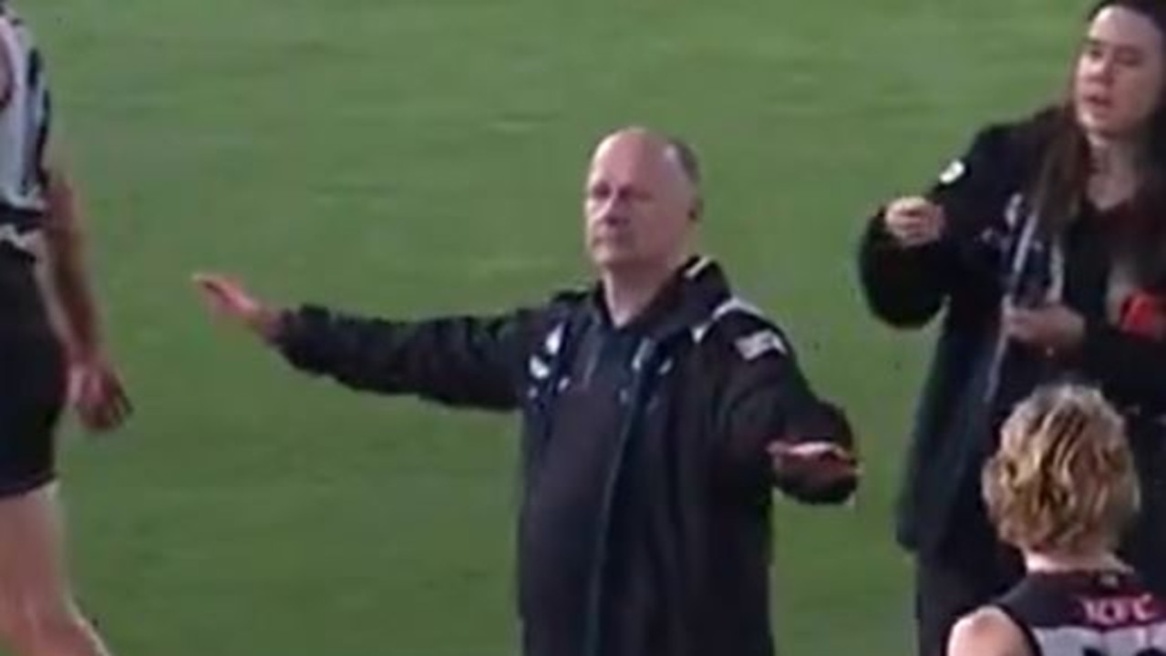 Ken Hinkley gestures to Hawk Jack Ginnivan that he won't be on a flight to Sydney for the prelim final. Picture: Fox Footy.