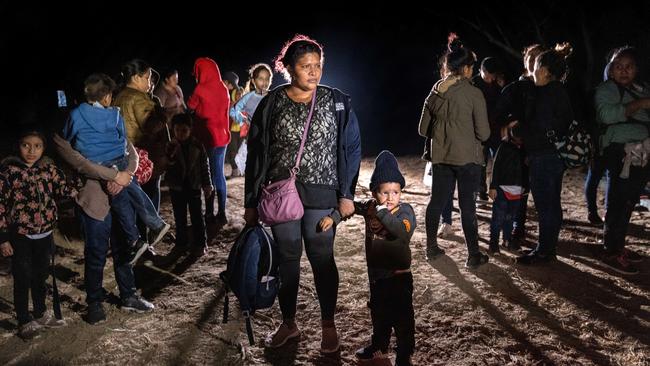 A Honduran mother and son, 3, stand on the bank of the Rio Grande after rafting across the border from Mexico on April 14 in Roma, Texas. Picture: AFP