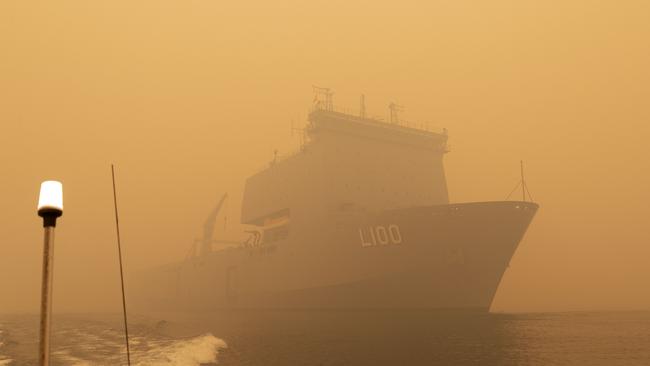 HMAS Choules sailing off the coast of Mallacoota to assist in bushfire relief efforts. Picture: AFP/Australian Navy