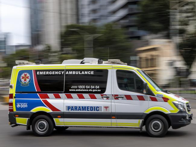 MELBOURNE, AUSTRALIA - NewsWire Photos FEBRUARY 13, 2022: An ambulance speeds away from the Royal Melbourne Hospital. Ambulance, Generic.Picture: NCA NewsWire / David Geraghty