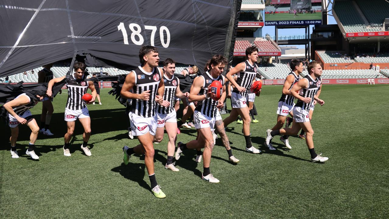 Magpies players run onto the field during the SANFL elimination final. Picture: David Mariuz