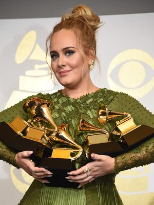 Adele poses poses in the press room. Picture: AFP