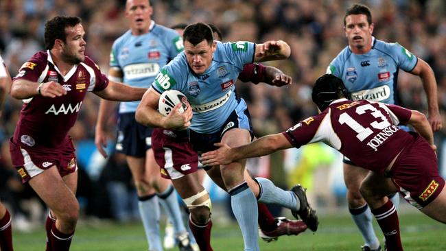 Ben Cross tries to break trough the Queensland defence in 2008.