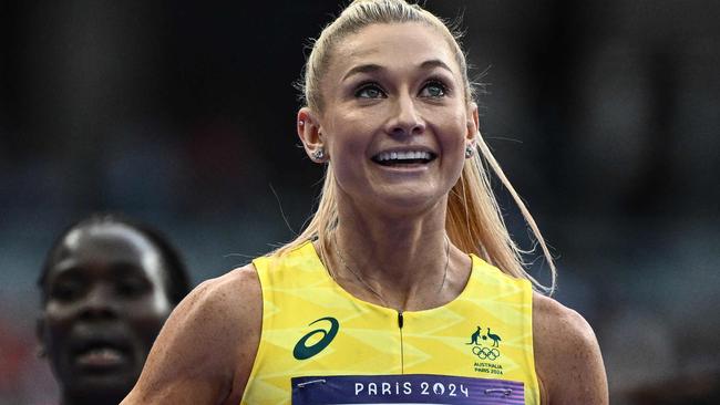 Australia's Jessica Hull and US' Nikki Hiltz react after competing in the women's 1500m semi-final of the athletics event at the Paris 2024 Olympic Games at Stade de France in Saint-Denis, north of Paris, on August 8, 2024. (Photo by Jewel SAMAD / AFP)