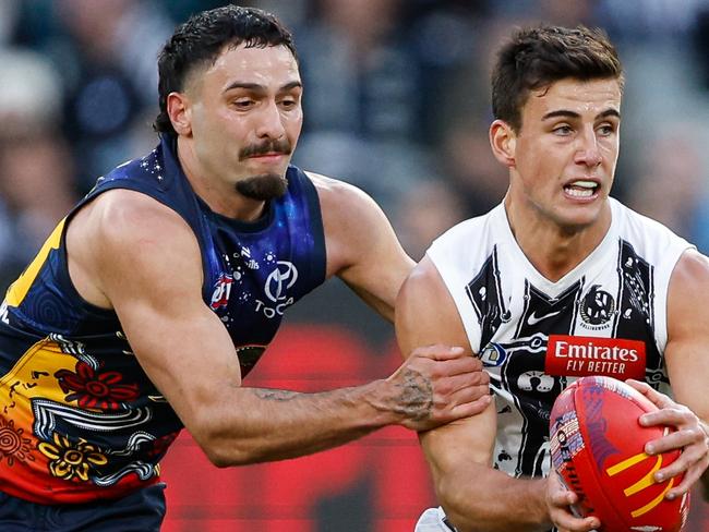 MELBOURNE, AUSTRALIA - MAY 18: Nick Daicos of the Magpies is tackled by Izak Rankine of the Crows during the 2024 AFL Round 10 match between The Collingwood Magpies and Kuwarna (Adelaide Crows) at The Melbourne Cricket Ground on May 18, 2024 in Melbourne, Australia. (Photo by Dylan Burns/AFL Photos via Getty Images)