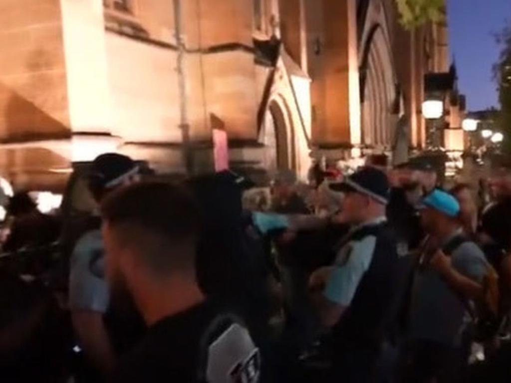 Footage shows supporters of the cardinal allegedly shouting at the silent protesters. Picture: 9 News