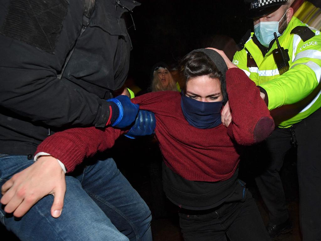 Police manhandle a woman at the vigil. Picture: AFP