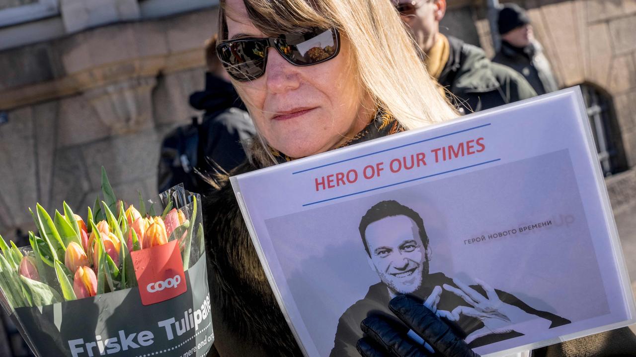 Protesters hold a picture of late opposition leader Alexei Navalny reading 'hero of our times' in front of the Russian embassy in Copenhagen. Picture: Emil Nicolai Helms / Ritzau Scanpix / AFP