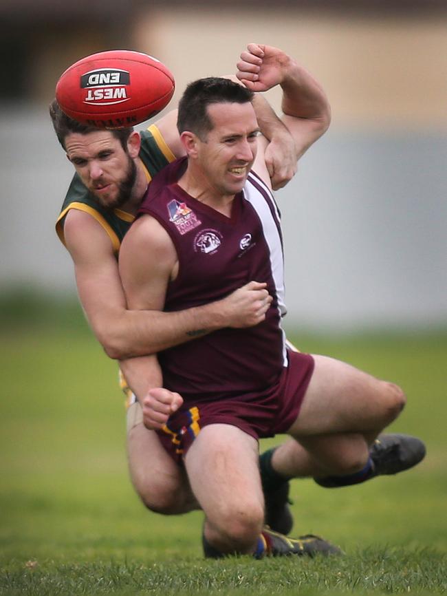 O’Sullivan Beach/Lonsdale’s Daniel Goodwin is tackled heavily by Marion’s Max McCallum when the sides met last month. Picture: AAP Image/Dean Martin