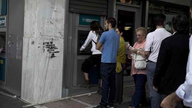 People line up at an ATM outside a branch of the National Bank, in central Athens, on Friday, June 19, 2015. Greece failed to secure a deal with bailout creditors on Friday, prompting the European Union to calls an emergency leaders' meeting for Monday. (AP Photo/Petros Giannakouris)